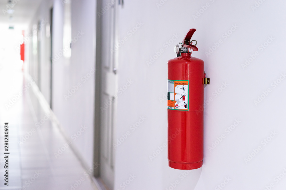 Fototapeta premium Fire extinguisher on wall in building