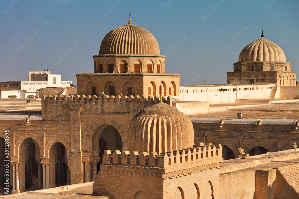 minarets of the Sidi Ukba mosque in Kairouan, Tunisia, Africa against the sky on a sunny day
