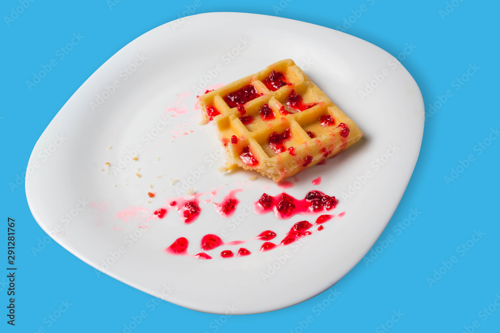 Belgian waffle with raspberry jam on a blue background. copy space Belgian waffle with raspberry jam on a blue background. copy space