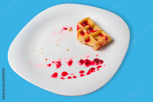 Belgian waffle with raspberry jam on a blue background. copy space