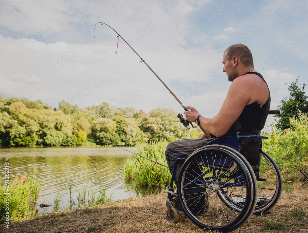 Handicapped man fishing at a lake. Wheelchair. Camping. Stock Photo | Adobe  Stock