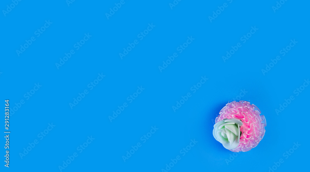 artificial flowers on a blue background frame for text. copy space artificial flowers on a blue background frame for text. copy space