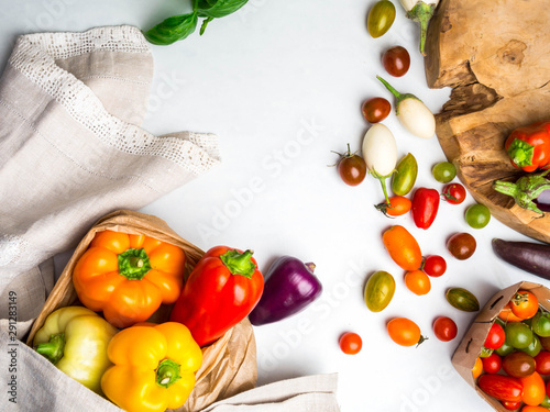 fresh vegetables on white background made of tomatoes, bell peppers, basil. Flat lay, top view, copy space, Healthy food and clean eating concept