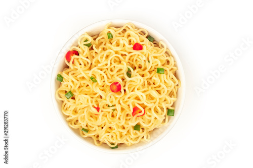 Soba noodles on a white background with red peppers and green onions, shot from the top