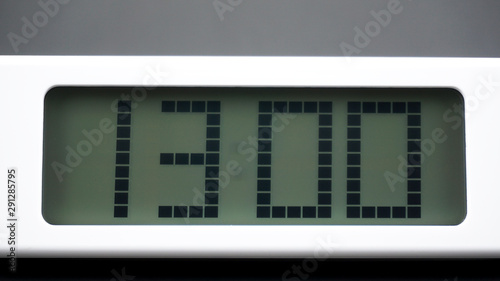 Digital alarm White clock time 13.00 am or pm on Black background, Time concept..
