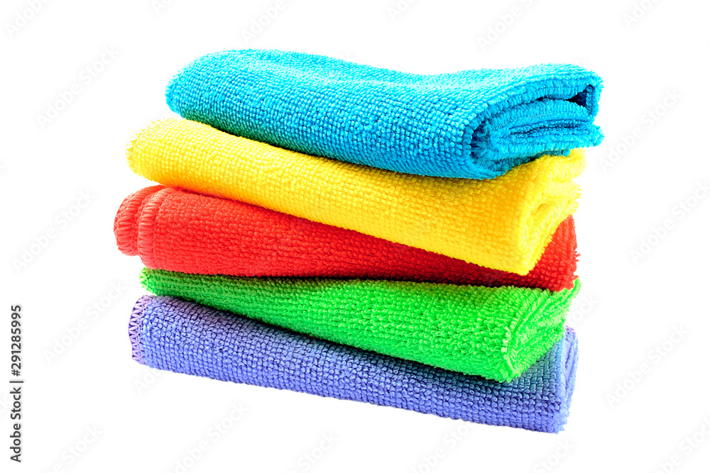 Colored bath towels isolated on white. Pile of bath towels isolated on a white background. A stack of colored towels. Multi-colored towels on a white background. Colored bath towels isolated on white. Pile of bath towels isolated on a white background. A stack of colored towels. Multi-colored towels on a white background.