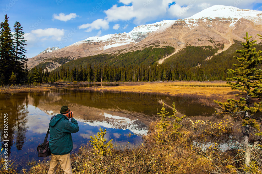 Man tourist in green jacket photographs Man tourist in green jacket photographs