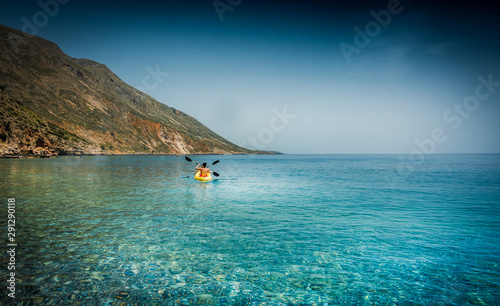 Tourist canoeing in blue sea of Greek islands, Greece