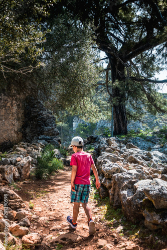 Boy exploring the roads of old Greek village, Greece