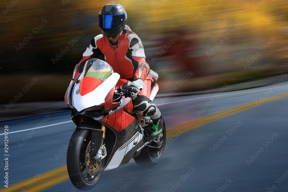 Motorcycle racer in helmet racing at high speed