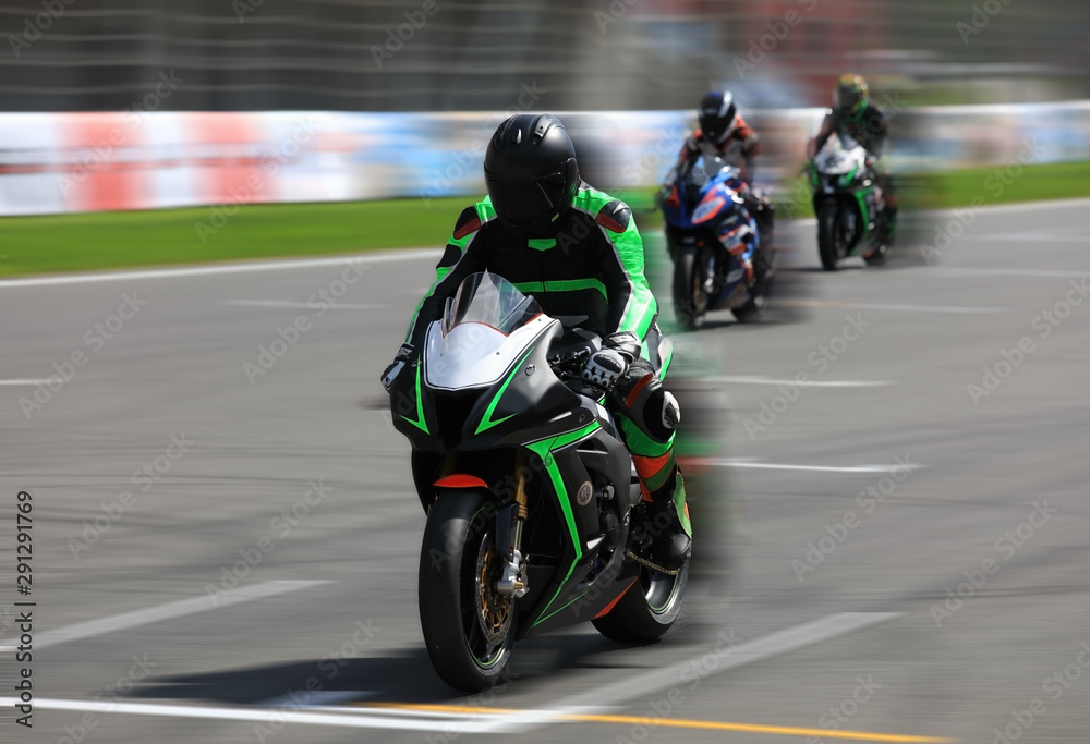 Motorcycle racers compete on the race track Motorcycle racers compete on the race track
