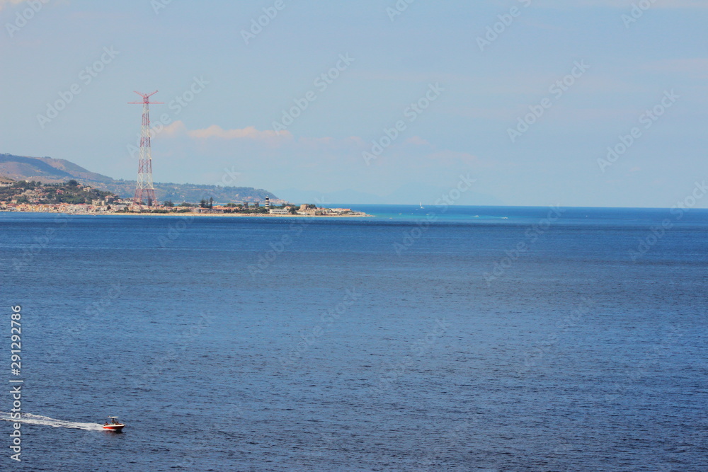 Torre Faro beach with metal voltage tower (pylon)