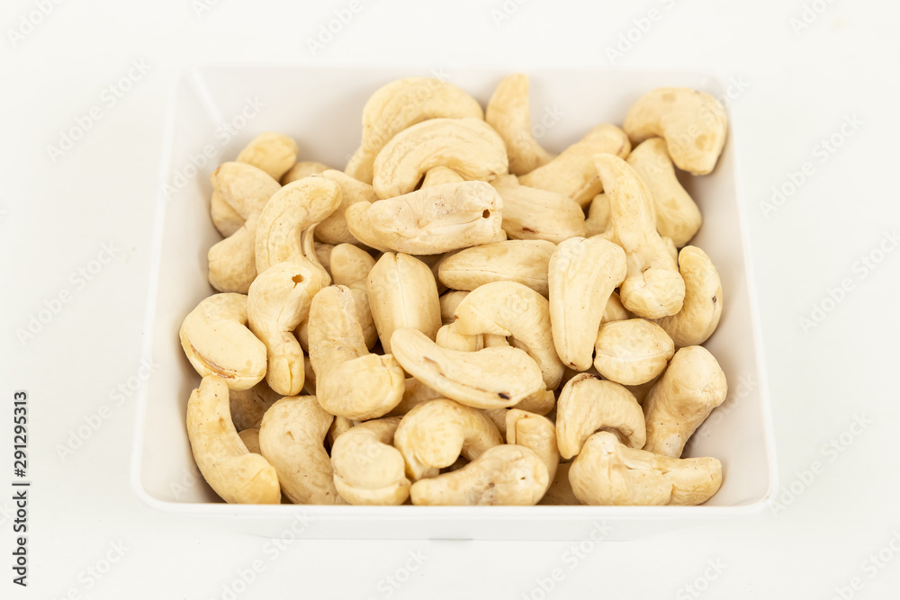 Cashew nut nut dried fruit in bowl on white background Cashew nut nut dried fruit in bowl on white background