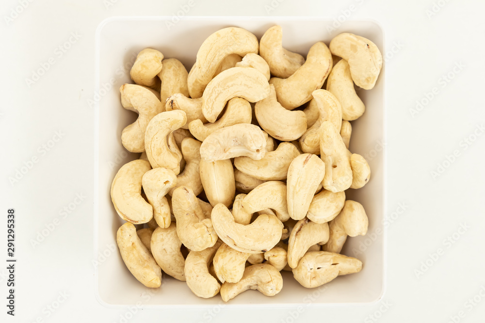 Cashew nut nut dried fruit in bowl on white background. Top view Cashew nut nut dried fruit in bowl on white background. Top view