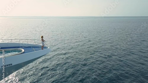 Woman on luxury private yacht in maldives ocean photo