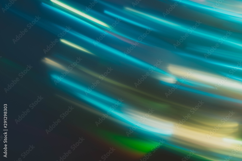 Fototapeta Blur night city lights in motion. Defocused neon aqua blue glowing lines. Dark abstract background.