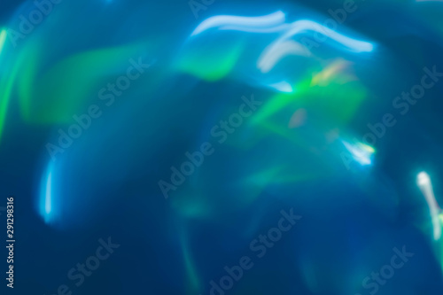Defocused glow. Blur shiny neon aqua blue and green lines. Abstract art background.