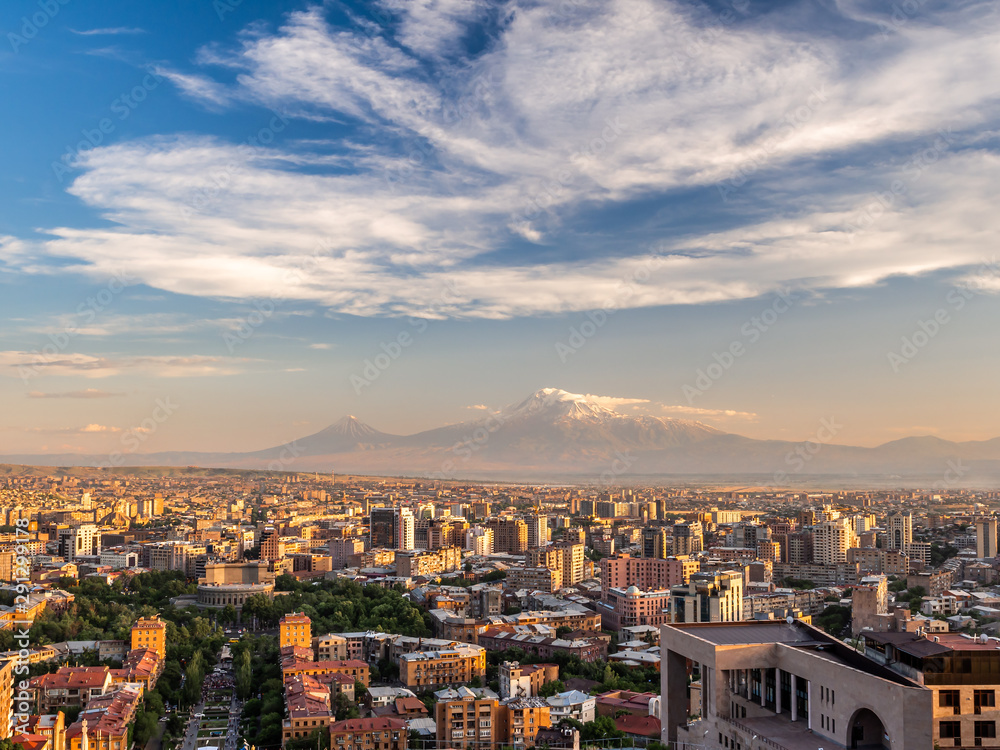 Yerevan city at sunset seen from the top of Cascade with magnificent Mount Ararat in the background.