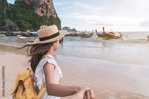 Young couple traveler enjoying a summer vacation at tropical sand beach in Krabi, Thailand