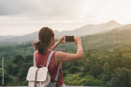 Young woman take a picture beautiful landscape with smartphone, Summer vacation and travel concept
