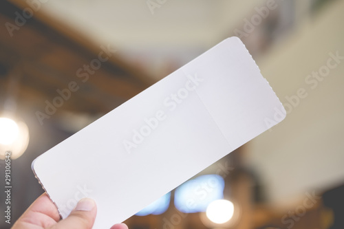 Empty paper air ticket in hand.