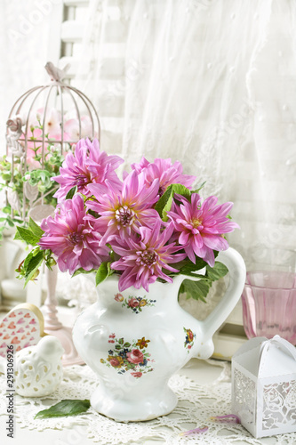 bunch of pink dahlia in porcelain jug
