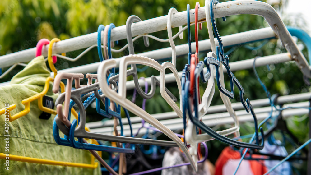 Various color of plastic cloth hangers hanging on the rack. Various color of plastic cloth hangers hanging on the rack.