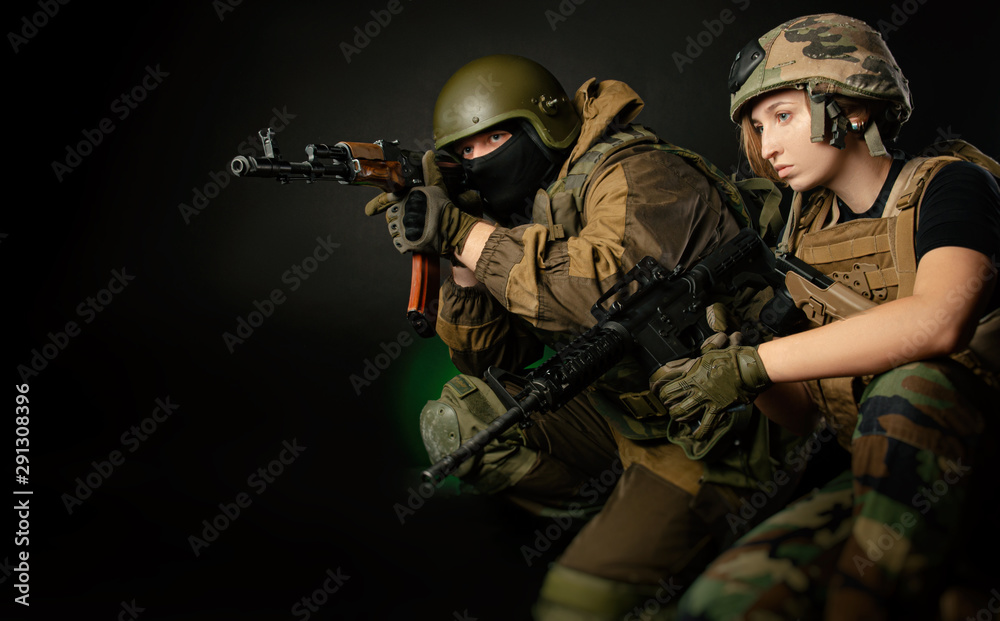 a soldier girl and a soldier guy work together on the assault