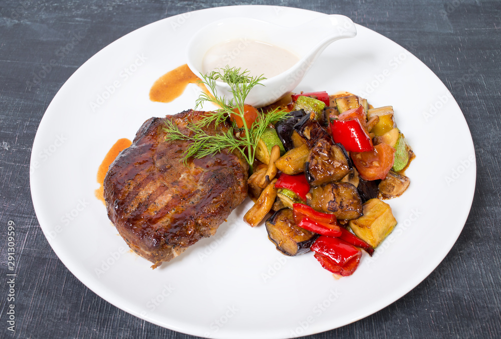 Grilled pork fillet with baked vegetables. Grilled pork fillet with baked vegetables.