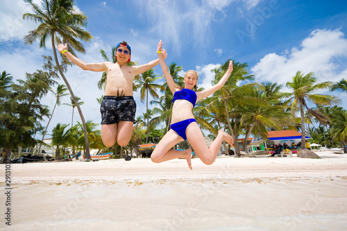 Happy teenagers jumping ove...