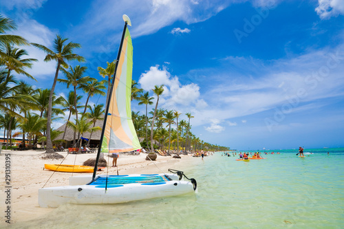 Fototapeta Naklejka Na Ścianę i Meble -  Sailboat moored at shore of tropical Bavaro beach in Sargasso sea, Punta Cana, Dominican Republic