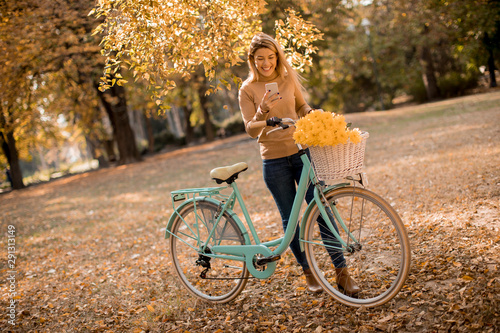 Young woman with bicycle us...