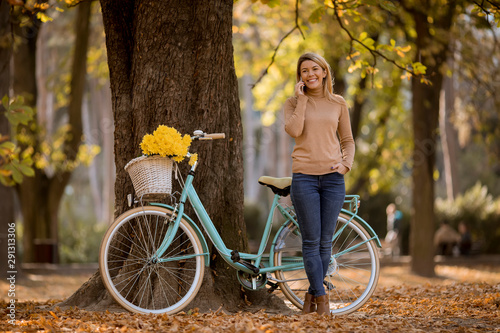 Young woman with bicycle us...