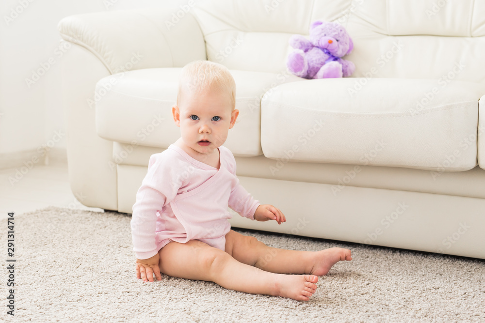 Child, childhood and kids concept - Portrait of charming baby girl on the couch Child, childhood and kids concept - Portrait of charming baby girl on the couch