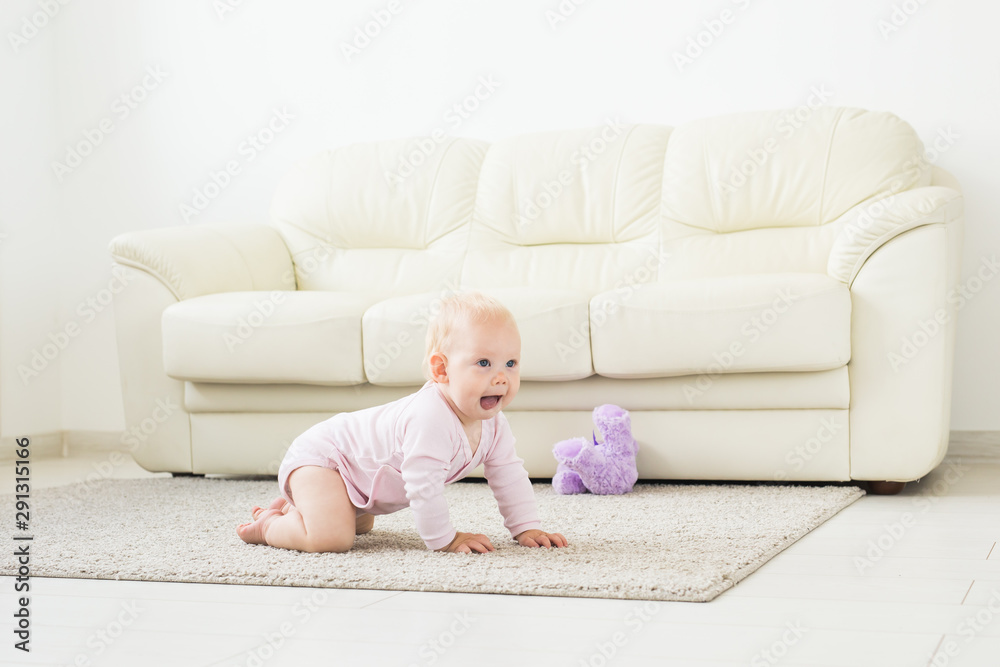 Portrait of a cute baby crawling and laughing on the floor at home Portrait of a cute baby crawling and laughing on the floor at home