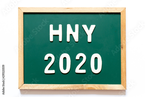 Green blackboard and wood frame with word HNY (Happy New Year) 2020 on white background