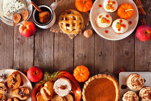 Autumn food double border. Table scene with a selection of pies, appetizers and desserts. Top view over a rustic wood background. Copy space. photo