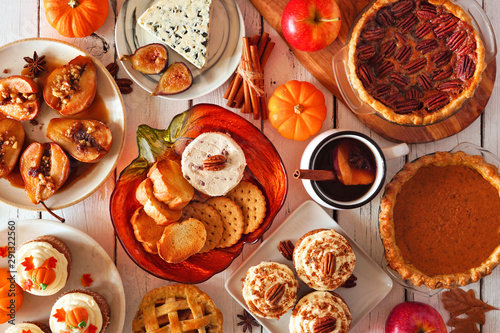 Autumn food concept. Selection of pies, appetizers and desserts. Top view table scene over a white wood background.