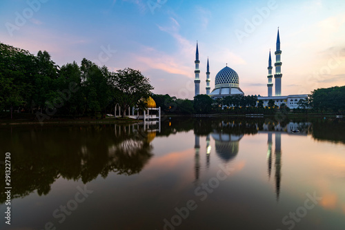Majestice view of Sultan Salahuddin Abdul Aziz Shah mosque in the morning by the lakeside at Shah Alam, Selangor.