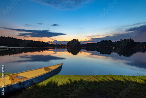 Beautiful sunset view in Wetland Putrajaya, Malaysia by the lakeside with a canoe.