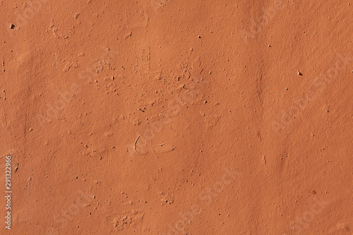 Terracotta painted stucco wall. Background texture