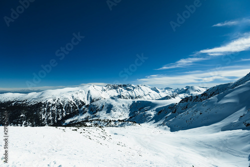Snowy ski slopes and chair ski lifts station in  mountain ski resort. © dbrus