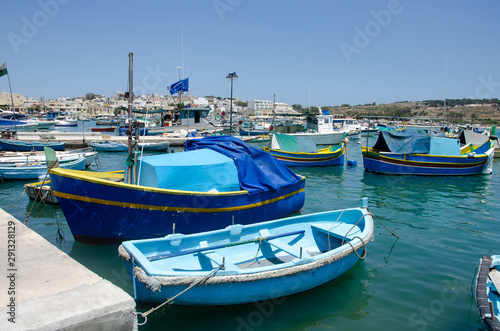 Traditional fishing boats Luzzu moored at Marsaxlokk Harbor  Malta