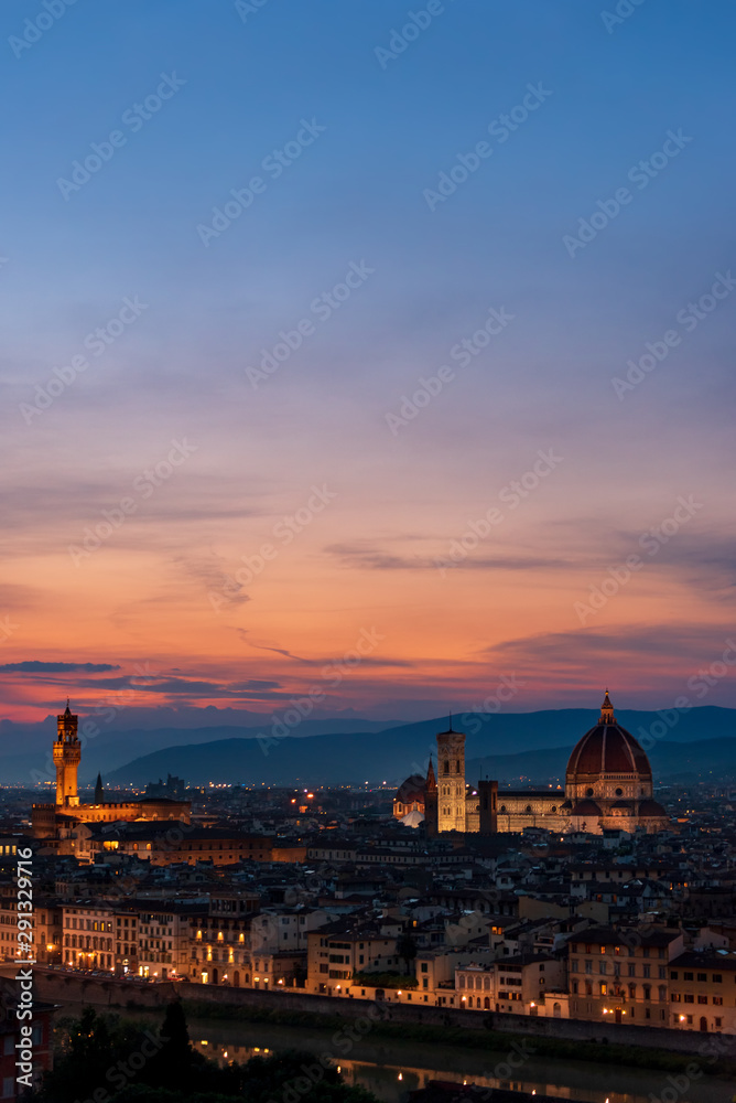 Florence sunset with Lungarno (Arno river bank), the cathedral and Palazzo Vecchio (medieval city hall) illuminated