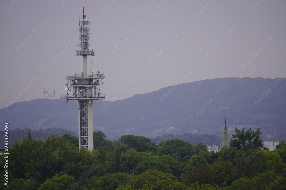 TV radio tower in the city, green modern city. transmission of signals to different parts of the country