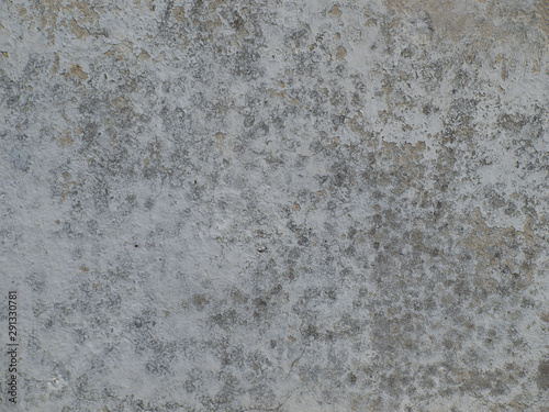  old gray plastered wall with plaster crumbled in some places