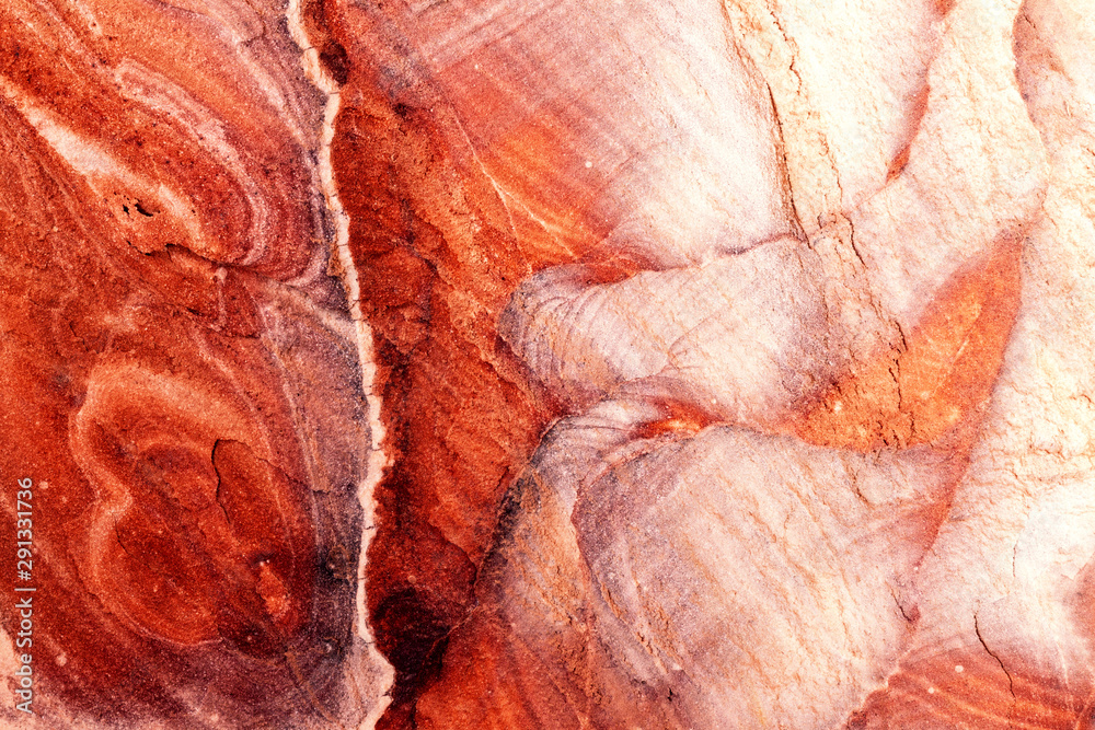 Jordan: rock face of Petra, with streaks that form red, white and yellow waves. Warm light, background, wallpaper. Jordan: rock face of Petra, with streaks that form red, white and yellow waves. Warm light, background, wallpaper.