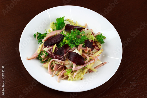 salad with meat, beets and vegetables in a plate
