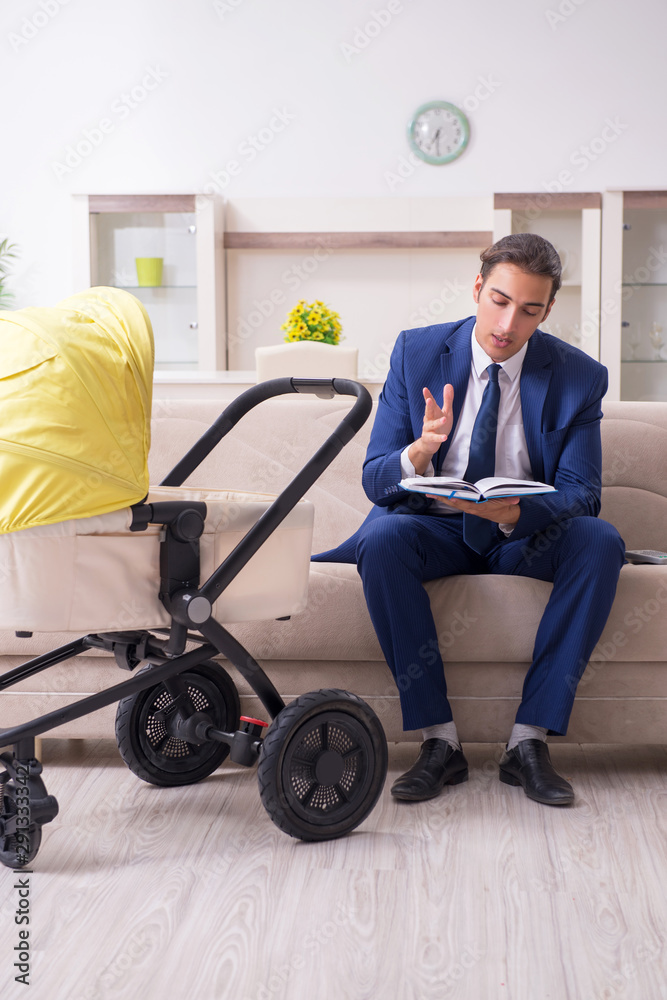 Young businessman looking after baby Young businessman looking after baby