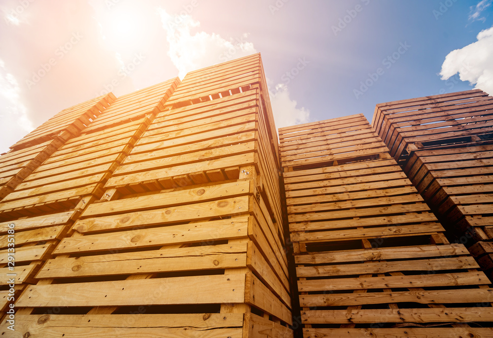 Wooden boxes stacked on each other. Outdoors. Blue sky background Wooden boxes stacked on each other. Outdoors. Blue sky background